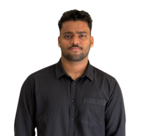 Portrait of a man wearing a black button-up shirt, standing against a plain background